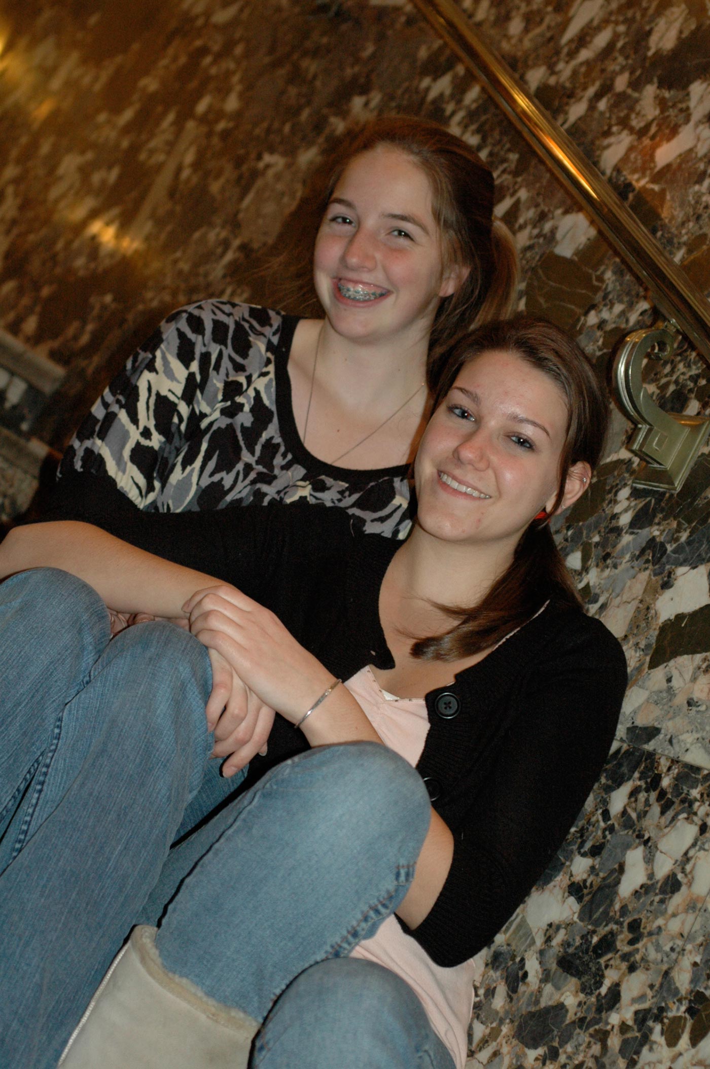 sisters_smiling_on_stairs